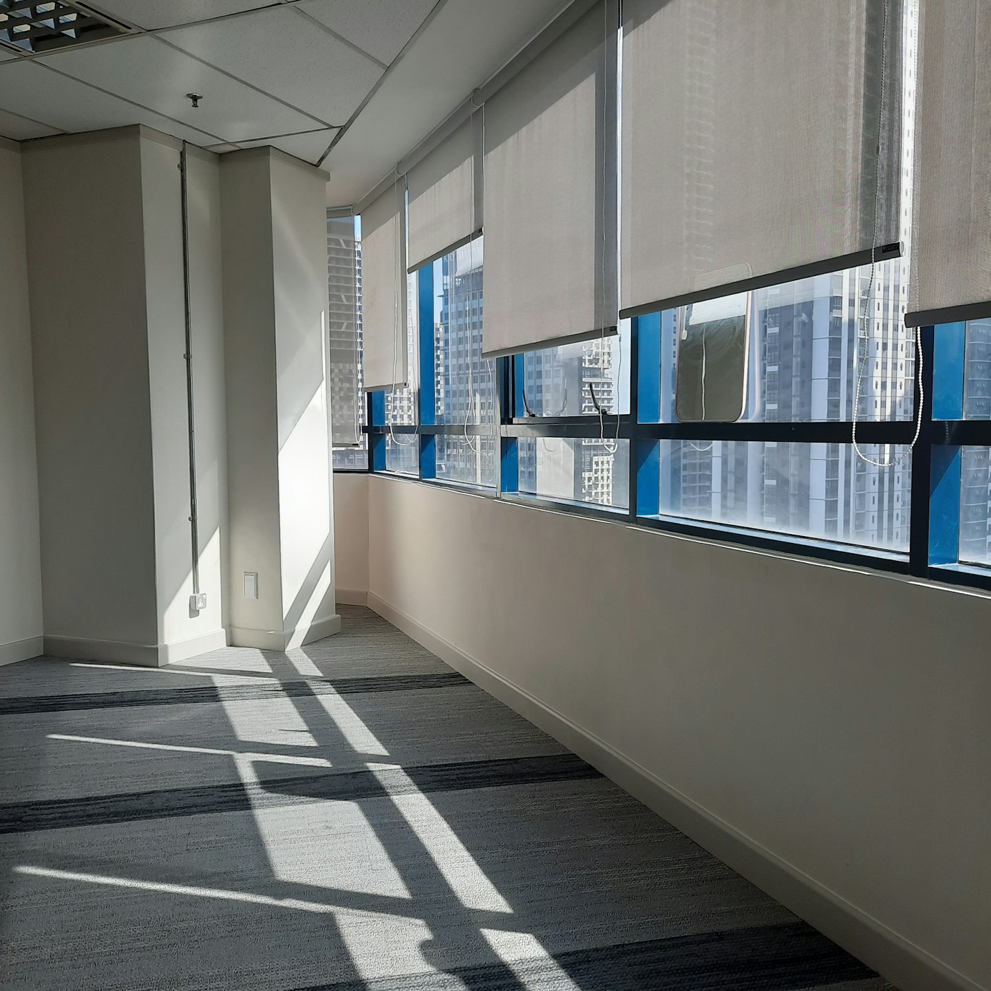 Leeres modernes Büro mit Fenstern und Blick auf die Stadtkulisse.